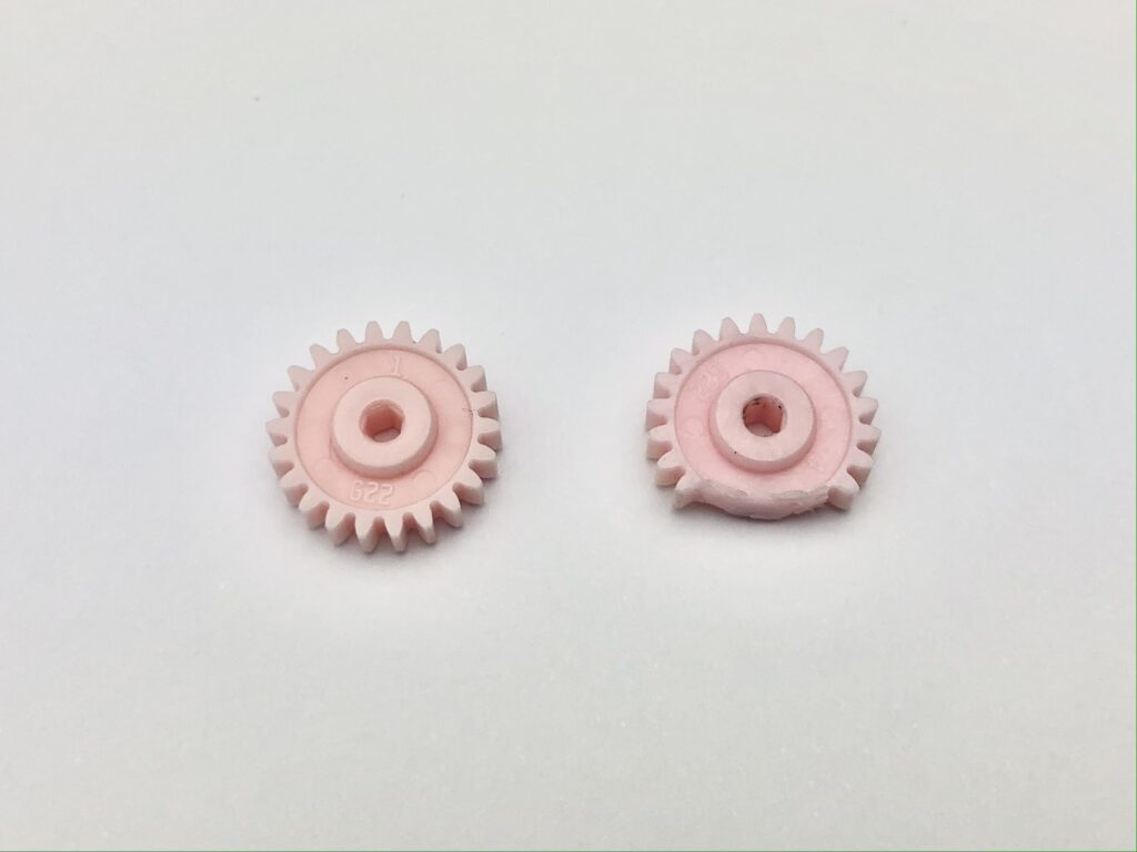 Cut pink gears on the right hand side vs the original on the left