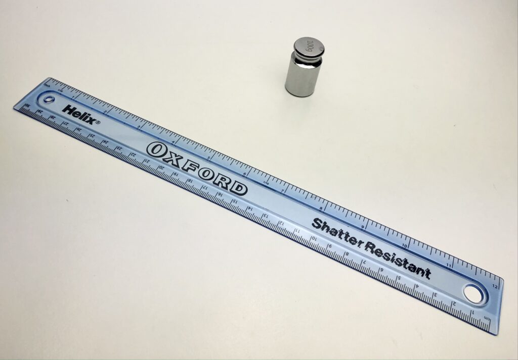 A picture of the ruler and a weight we used for the tyre bounce experiment